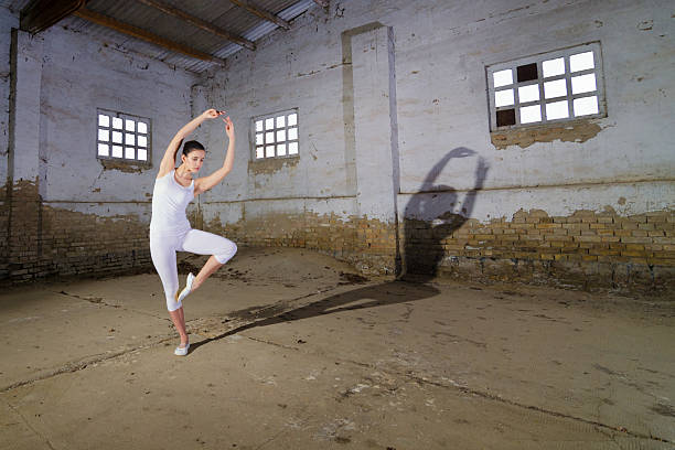 istock Ballerina dancing in an abandoned building 2220985942