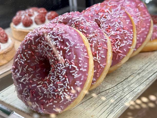 Enjoy delightful Pink Frosted Donuts with colorful sprinkles, perfect for any occasion. A wonderfully tempting display of pinkfrosted donuts that are beautifully topped with colorful sprinkles
