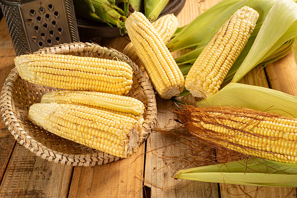 istock Green corn, green corn cobs and accessories on a rustic wooden table, selective focus. 2220986790