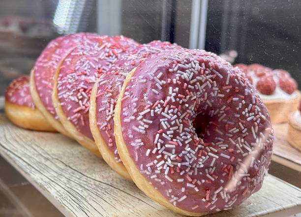 Enjoy delightful Pink Frosted Donuts with colorful sprinkles, perfect for any occasion. A wonderfully tempting display of pinkfrosted donuts that are beautifully topped with colorful sprinkles
