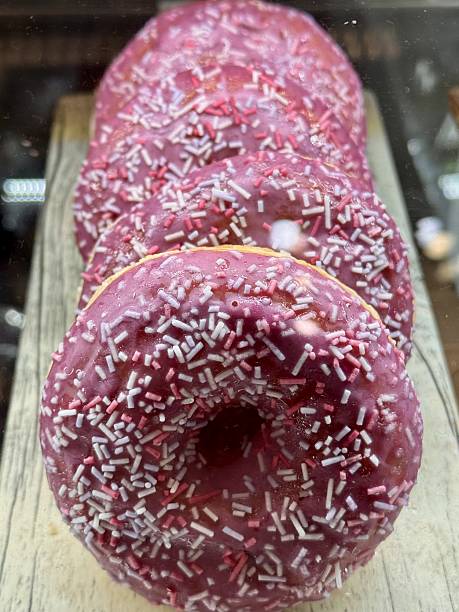 Enjoy delightful Pink Frosted Donuts with colorful sprinkles, perfect for any occasion. A wonderfully tempting display of pinkfrosted donuts that are beautifully topped with colorful sprinkles
