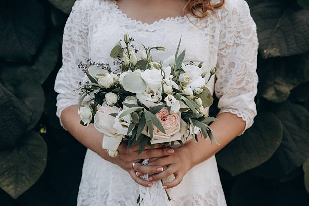 istock Bride holding wedding bouquet with beautiful flowers. 2220987661