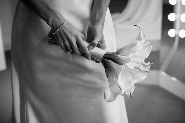 Bride holding wedding bouquet with beautiful flowers.