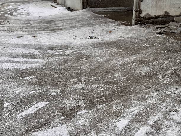 istock A captivating urban street scene with light snow and scattered debris, blending textures. A gray urban sidewalk covered lightly with fresh snow, with scattered debris visible amid a wintery scene 2220991120