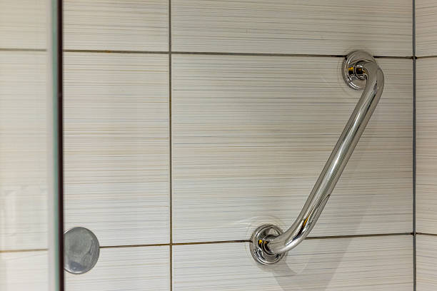 istock Chrome bathroom handle mounted on the wall inside the shower cubicle. 2220993425