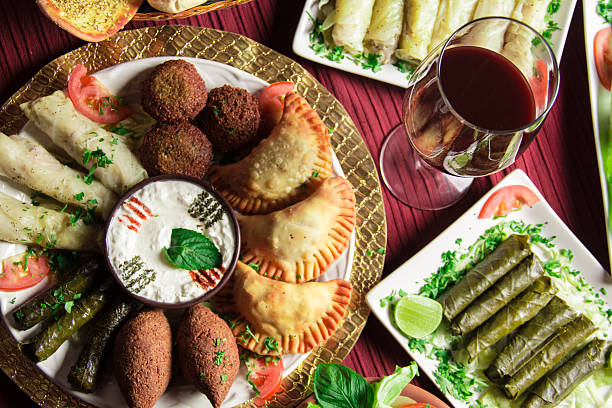 istock A vibrant display of assorted appetizers like stuffed pastries, dips, and salads, all beautifully arranged to invite guests to enjoy the flavors of Middle Eastern cuisine. 2220995601