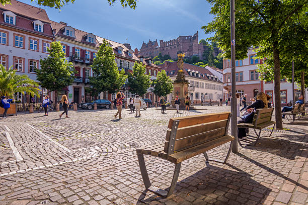 colorful facades at Korn Market square in Heidelberg at sunny summer day with fountain in the middle