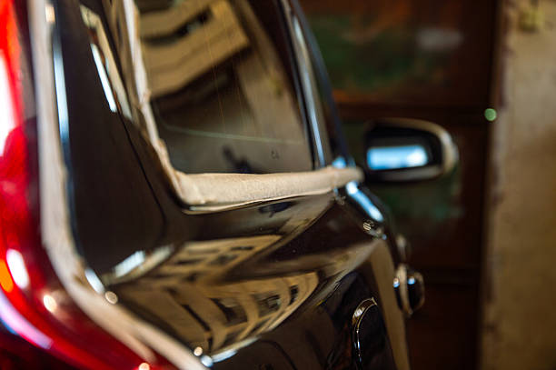 istock Vehicle being polished meticulously, highlighting the shiny surface in a well-lit garage environment during the day 2220996916