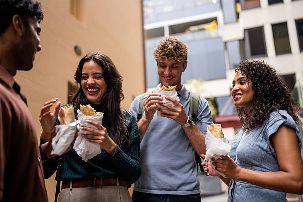 istock Friends Enjoying Wrap Sandwiches Together 2221000638