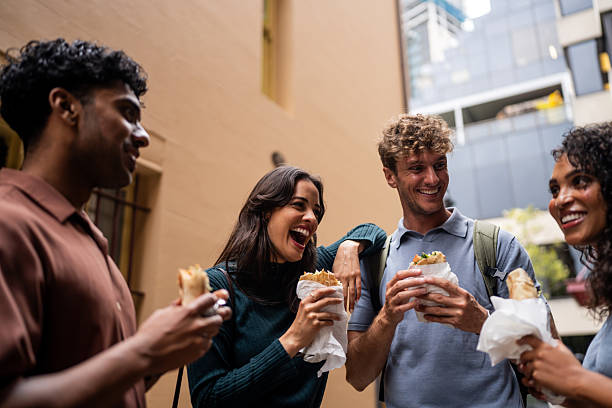 istock Friends Enjoying Wrap Sandwiches Together 2221000670