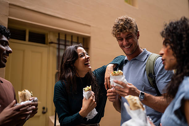 istock Friends Enjoying Wrap Sandwiches Together 2221000675