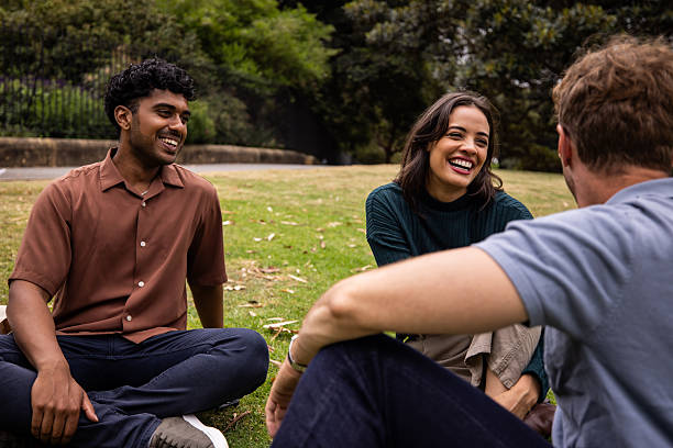 istock Friends Relaxing on the Grass in Sydney Park 2221000731