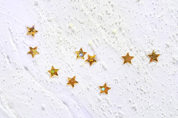 istock Gold star sequins on white texture creating a festive and elegant abstract 2221001349