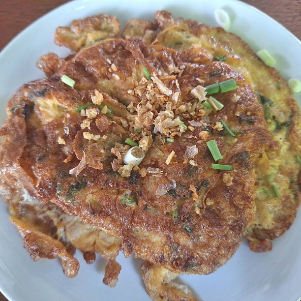 istock Thai Crispy Omelet Topped with Fried Garlic and Scallions 2221002918