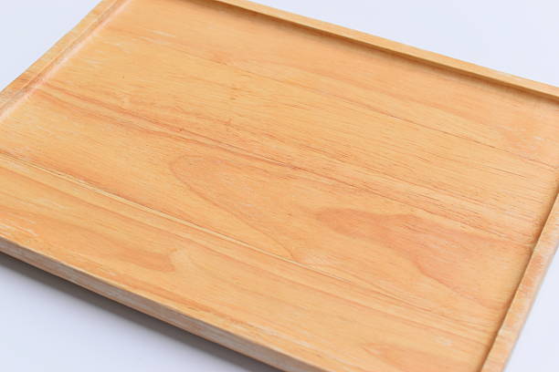 Wooden round board for serving delicious food on a wooden surface close-up