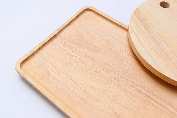istock brown wooden tray and sphere cuttingboard isolated on white background 2221004454