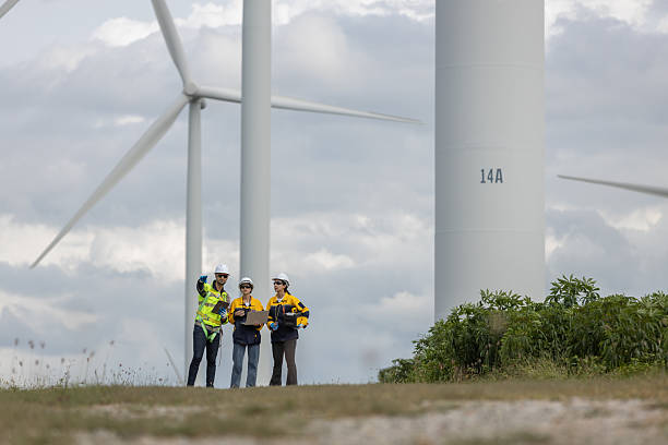 istock Engineer wearing safety uniform using laptop discussed plan about renewable energy at station energy power wind turbine. technology protect environment reduce global warming problems. 2221004959