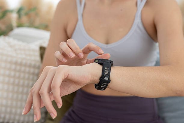 istock Person pointing touching at smart watch screen display. smart wristwatch use for text electronice, Message notifications, heart rate measurement during exercise. 2221005480