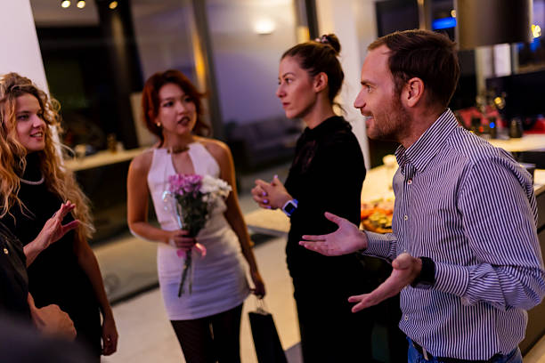 istock A group of people socializing at an indoor gathering with friendly interactions 2221011764