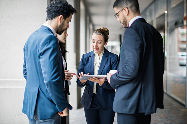 istock Business Discussion in Modern Office Hallway 2221016340