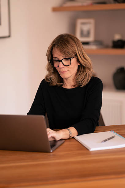 istock Blond haired proffessional female using laptop at home 2221016716