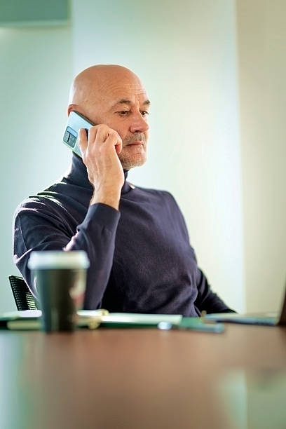 istock Senior businessman using a smartphone in a modern office 2221016744