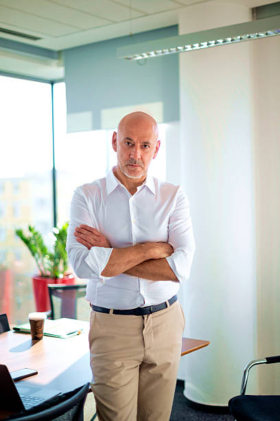 istock Confident businessman standing at his desk in the office 2221016783