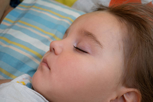 Portrait of a cute sleeping baby on a bright pillow