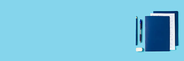 istock Back to school, education banner design, notebook with math formulas paper, pen, pencil and eraser, stationary accessories on blue background, copy space 2221019397
