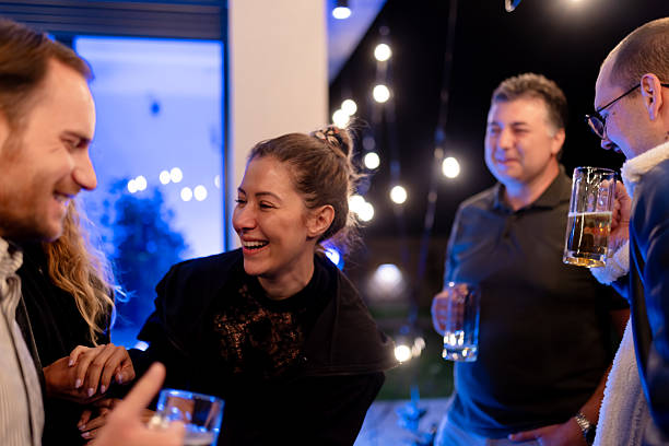 istock Group of friends enjoying an evening gathering outdoors with drinks 2221023565