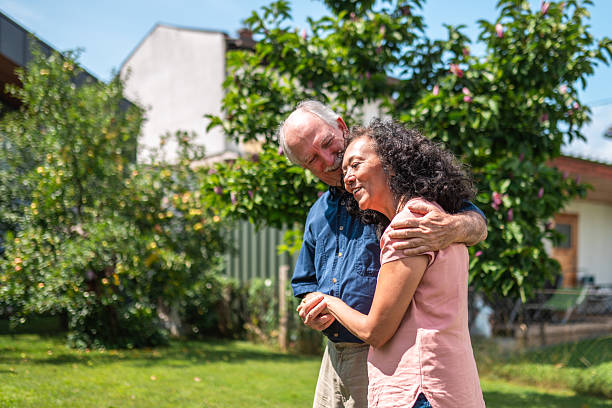 istock Affectionate Elderly Caucasian Man Embracing Hispanic Woman in Garden 2221023635