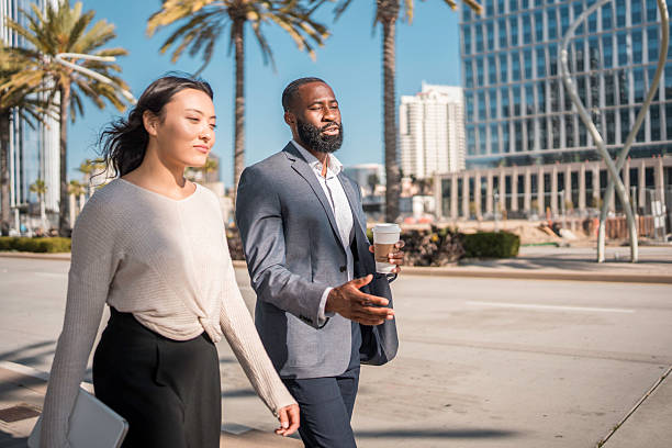 istock Two Diverse Business Professionals Walking Outdoors 2221025045