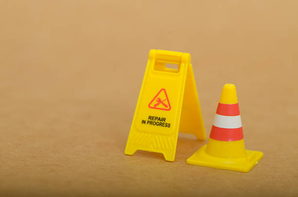Yellow Repair in Progress Sign: Symbol of Caution and Incomplete Work in a Conceptual Visual Format