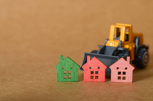 istock Toy Digger with Colorful Mini Houses Symbolizing Real Estate Development 2221025222