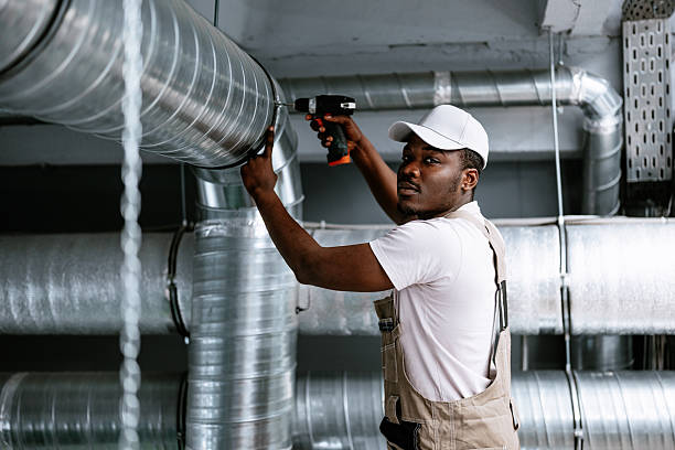 istock Skilled technician installs ventilation system in industrial setting during the day 2221030555