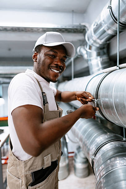 istock Skilled worker performs maintenance on industrial piping in a modern facility 2221030559