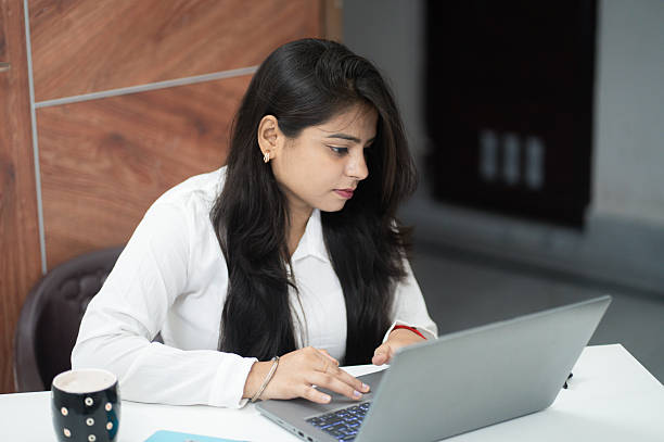 istock Young Woman Typing on Laptop in Modern Workspace 2221030949
