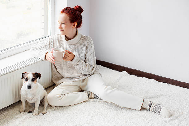 istock Young Woman Drinking hot coffee at white room 2221030989