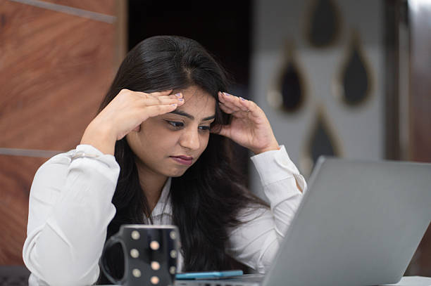istock Young Woman Feeling Overwhelmed at Work Desk 2221031238