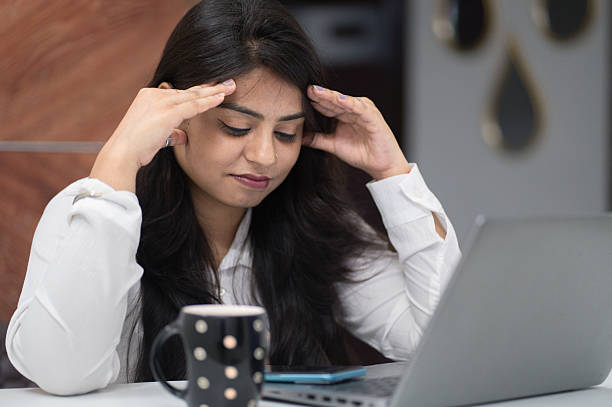 istock Young Woman Feeling Overwhelmed at Work Desk 2221031324