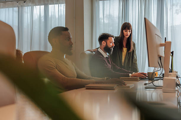 istock Business team working together on a computer in the office 2221031592