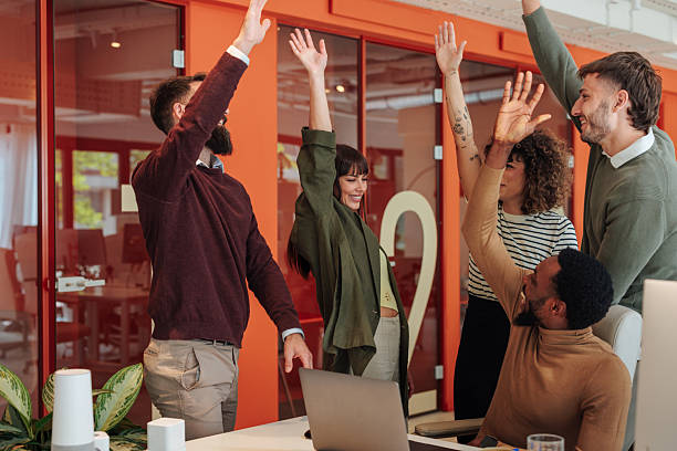 istock Excited business team celebrating success in modern office 2221031639