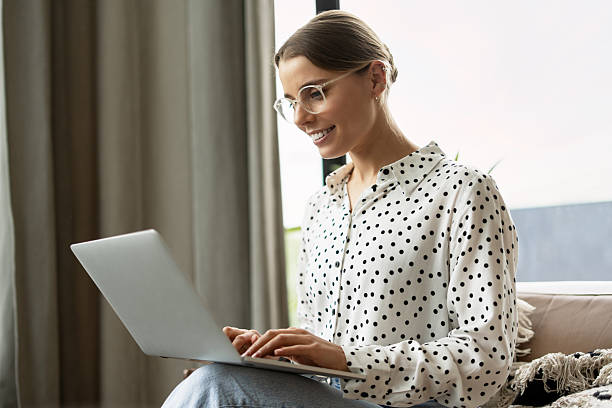 istock Smiling businesswoman working remotely from home using laptop 2221033948
