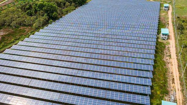 istock Expansive solar panel field generating clean energy amidst natural surroundings. 2221038821