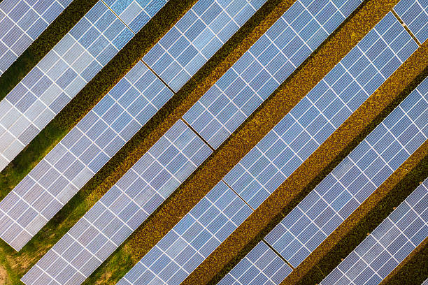 istock Expansive solar panel field generating clean energy amidst natural surroundings. 2221038858