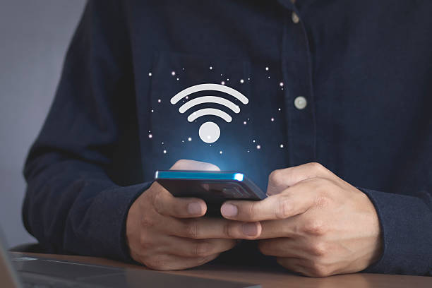 istock Wi-Fi internet, wireless network with icons on young man's hand 2221038956