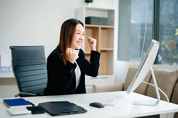 istock Asian working on laptops and tablets in a stylish office. Perfect for creativity, remote work, modern lifestyle, and startup themes. 2221039387