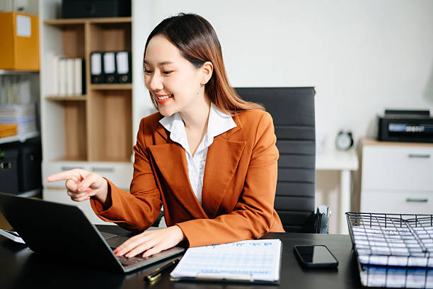 istock Asian working on laptops and tablets in a stylish office. Perfect for creativity, remote work, modern lifestyle, and startup themes. 2221039399