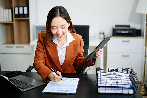 istock Woman freelancer is working her job on computer tablet and laptop Doing accounting analysis report real estate investment 2221039405