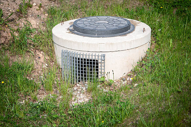 istock Underground Concrete Utility Access with Manhole Cover and Grated Drain Vent in Grass Field 2221041859